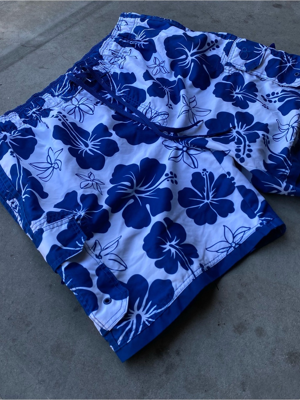Ocean Pacific blue floral pattern swim trunks with white mesh lining